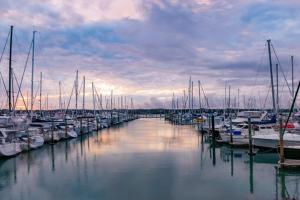 a group of boats docked in a marina at Red Beach Retreat in Red Beach +5 photos