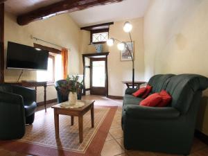 a living room with two couches and a tv at Gîte familial avec grande terrasse à Auzat, proche baignades et sites historiques - FR-1-582-183 in Villeneuve-dʼAllier