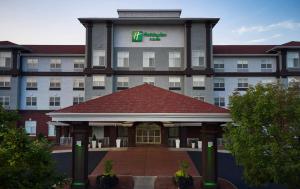 a hotel with a building with a sign on it at Holiday Inn Hotel & Suites Madison West - Middleton by IHG in Middleton