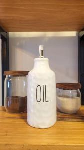 a white oil container sitting on a counter with two bowls at Apartamentos Monarca in Siguatepeque