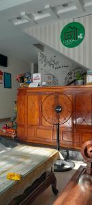 a wooden counter in a room with a table at Lucky Hotel in Hoi An