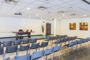 a room with chairs and a table and a desk at Hotel Gallia in Pianezza