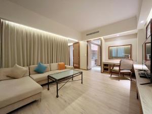 a living room with a couch and a table at Jia Hsin Garden Hotel in Tainan