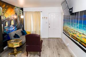 a living room with a couch and a painting on the wall at Artful Retreat - King Bed, Work Desk, WIFI, Unique Murals, Perfect for Business Travelers, Downtown & Near Universal Studios in Burbank