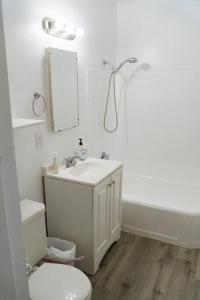 a bathroom with a sink and a toilet and a mirror at Artful Retreat - King Bed, Work Desk, WIFI, Unique Murals, Perfect for Business Travelers, Downtown & Near Universal Studios in Burbank