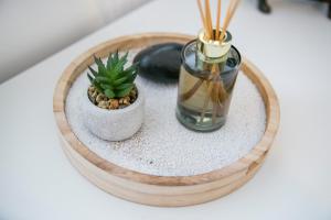 a small plant on a wooden tray with a vase at Maidencraig Court House ✪ Grampian Lettings Ltd in Aberdeen