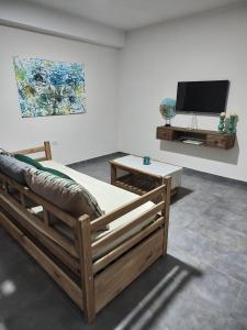 a living room with two beds and a tv at Duplex Del Valle in San Fernando del Valle de Catamarca