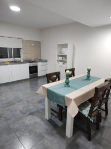 a dining room with a table and chairs and a kitchen at Duplex Del Valle in San Fernando del Valle de Catamarca
