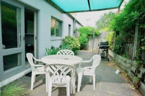 a white table and chairs on a patio at Glan Mor in Queenscliff