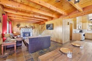 ein Wohnzimmer mit einem Sofa und einem Kamin in der Unterkunft The Getaway Cabin in Big Bear City