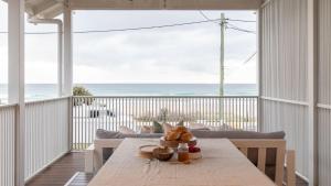 a dining room with a table and a view of the ocean at Rigi on Currumbin Beach in Gold Coast