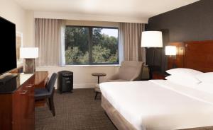a hotel room with a large bed and a window at Marriott Raleigh Durham Research Triangle Park in Durham +52 photos