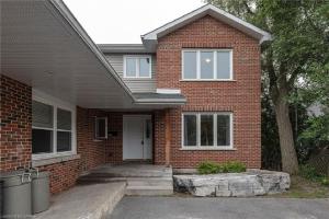 a red brick house with a white door at Nice Rooms Stay - Unit 2 in Kingston