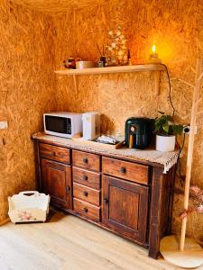 a wooden cabinet with a microwave on top of it at holiday tiny house near park in Vermont South