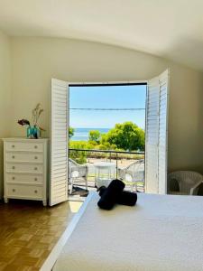 a bedroom with a bed and a view of a balcony at Stunning Ocean View Villa 2 Dunsborough in Dunsborough +17 photos