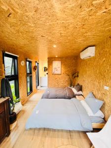 a bedroom with a large bed in a stone wall at holiday tiny house near park in Vermont South