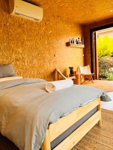 A bed or beds in a room at holiday tiny house near park