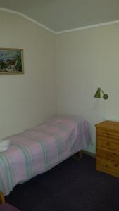 una piccola camera da letto con un letto e una cassettiera di Tana Vertshus a Bånjakas