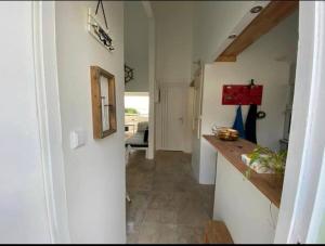 a kitchen with a counter and a hallway at Le Lantana by EGL IMMO in Le Marin