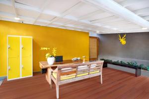Habitación con escritorio y pared amarilla. en La Mira Villa Seminyak by Ini Vie Hospitality, en Seminyak