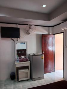 a kitchen with a refrigerator and a table and a door at Kalisa House@Soi welcome in Jomtien Beach +15 photos