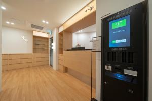 a atm machine in a room with a hallway at The Hyoosik Aank Hotel Cheonan Station 1st Branch in Cheonan