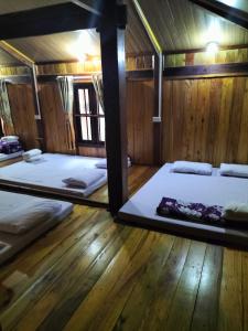 a room with two bunk beds and a mirror at Nặm Pé Homestay in Bak Kan