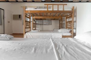 two beds in a room with two bunk beds at Casa Toboro in Taganga