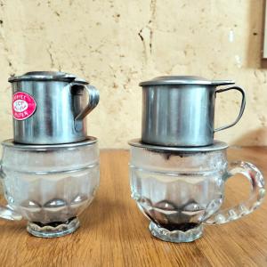 two silver coffee pots sitting on top of a table at Hong Thu Homestay & Bungalow in Quang Ba