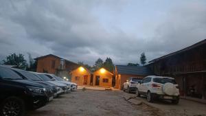 a group of cars parked in front of a house at Hong Thu Homestay & Bungalow in Quang Ba