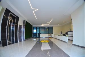a large room with a kitchen and a living room at Seasons Stay in Vijayawāda