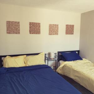 two beds sitting next to each other in a bedroom at Baja's Rest Stop in San Felipe
