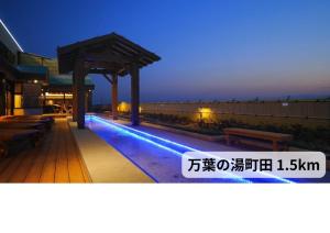 a building with a swimming pool at night at 艶横浜町田店 adult only in Yokohama