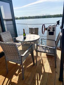 a table and chairs on the deck of a boat at TRAUMZEITBOOT auf dem Scharmützelsee Bad Saarow in Bad Saarow