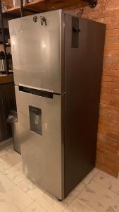 a stainless steel refrigerator sitting in a kitchen at INDUSTRIAL.SMART HOME in Mérida