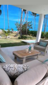 a patio with a table and a view of the beach at Villa Brise de Mer in Las Terrenas