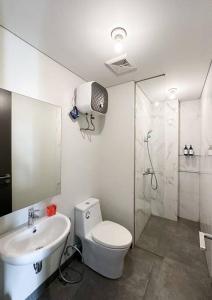 a bathroom with a toilet and a sink and a shower at One Residence Apartment 2BR near Ferry Terminal in Batam Center