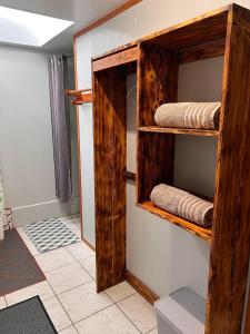 a room with wooden shelves with folded towels at Moorea Vaiare Lodge in Moorea