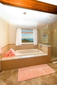 a large bathroom with a tub and a window at Gorgeous Oceanview, by OceanviewHotTubs Oceanfront! Shelter Cove, CA Tesla EV Station in Shelter Cove +60 photos