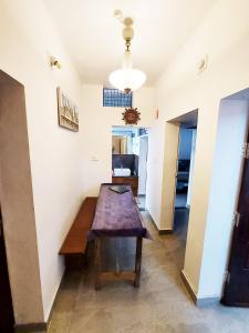 a room with a wooden table in a room at Forestay -3 BHK Villa Kochi in Pallipuram