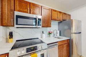 a kitchen with a stove and a microwave and a refrigerator at Club Wyndham 521 in Myrtle Beach