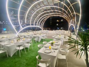 a banquet hall with white tables and white chairs at Aurora Suites in Manila