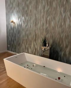 a white bath tub in a room with a wall at Wunderschönes Loft in Stadtmitte in Koblenz