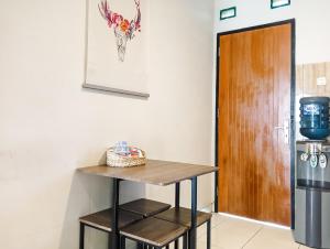 a small kitchen with a table and a door at Sleep House 2BR Wifi Unlimited in Cirebon