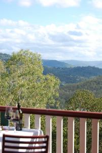 a table and chairs on a balcony with a view at Nunyara Retreat. Quality bush retreat in Wolfdene