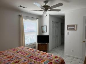 a bedroom with a bed and a ceiling fan at South Shores I 3 Condo in Myrtle Beach