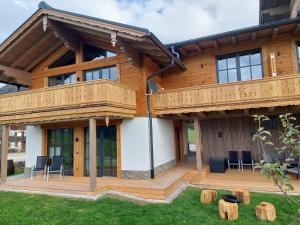 a log home with a deck and patio at Chalet Schintlbauer in Annaberg im Lammertal