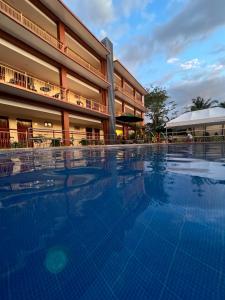 a large swimming pool in front of a building at Rufana Suites in Moalboal