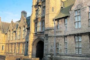 a large brick building with an archway in front of it at No. 1 Orange St in Uppingham