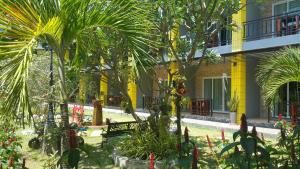 un patio con palmeras y un edificio en Greenery Resort Koh Tao, en Ko Tao